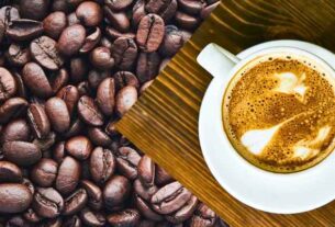 A perfect cup of coffee with coffee beans - Illustrating the Benefits of Caffeine.
