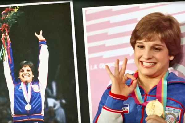 Mary Lou Retton proudly displaying her Olympic gold medal