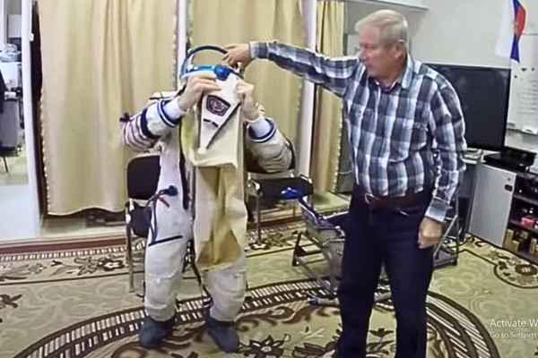The Astronaut Trying on Prada's Innovative Space Suit with Designer's Assistance.