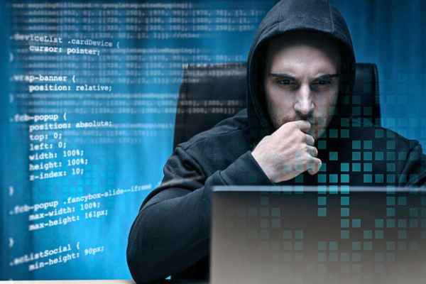 An individual involved in planning cybercrime activities on The Dark Web, illustrating the dangers associated with this hidden realm.