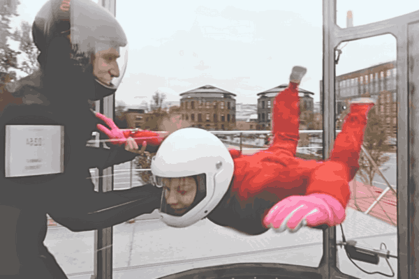 Indoor Skydiving Instructor guiding a trainee - Focus Keyphrase: Indoor Skydiving