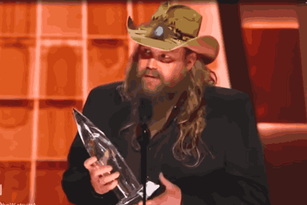 Chris Stapleton, the maestro, embraces his CMA Awards 2023 victory, holding the coveted Male Vocalist of the Year trophy in a display of pure musical prowess.
