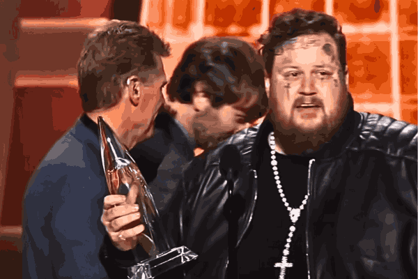 Jelly Roll radiates joy, holding the esteemed CMA Awards 2023 trophy, a symbol of his inspirational win for Best New Artist in the country music scene.