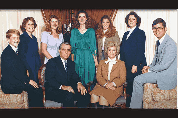 M Russell Ballard surrounded by his 7 children in a heartwarming family photo.