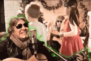 Children celebrating Christmas with decorations, immersed in Feliz Navidad Lyrics and Song as Jose Feliciano strums his guitar.