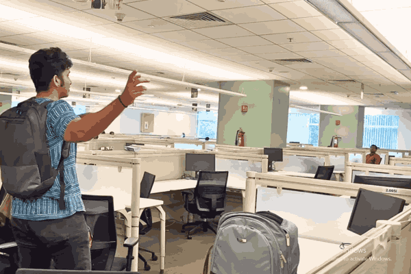 EY Layoffs: Employee leaving deserted EY office