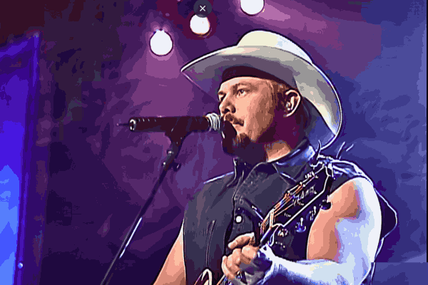 Toby Keith performing on stage, singing his iconic songs to the crowd.