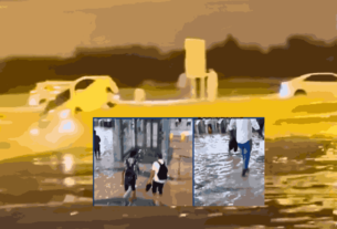 Cars submerged in floodwaters and people wading through flooded metro station due to severe Dubai weather.
