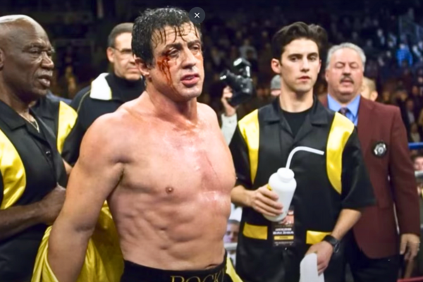 Sylvester Stallone stands triumphant in a boxing ring, representing the resilience showcased in Rocky II.