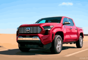 A sleek Toyota Tacoma Hybrid driving on the road, showcasing power and performance