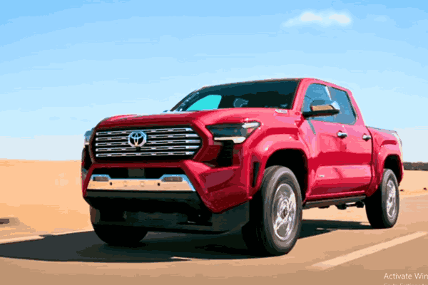 A sleek Toyota Tacoma Hybrid driving on the road, showcasing power and performance