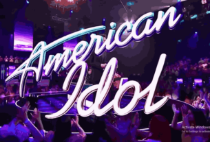 Spotlights shining on the stage with 'American Idol Finale' illuminated in bold letters.