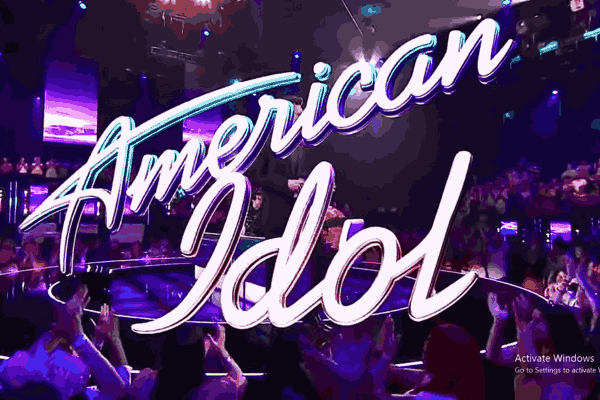 Spotlights shining on the stage with 'American Idol Finale' illuminated in bold letters.