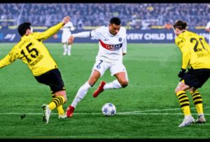 Two soccer teams, PSG and Dortmund, face off in a dramatic Champions League clash, showcasing the PSG Vs Dortmund rivalry.