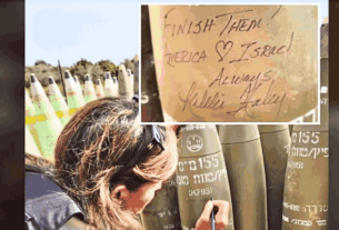 Nikki Haley writing a message on an Israeli shell during her visit to an artillery post in Israel.