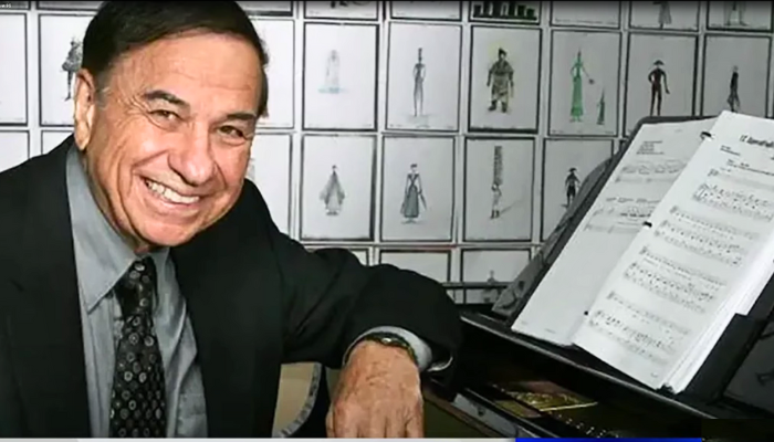 Richard Sherman, legendary Disney songwriter, at a piano composing music.