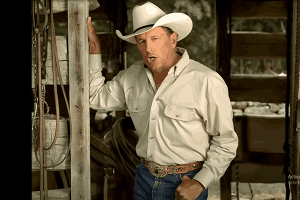 George Strait singing a song in a countryside setting, featured in one of his video clips.