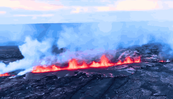 A dramatic aerial view of the Hawaii Kīlauea Volcano Eruption, showcasing volcanic material being launched into the air during the unique "stomp-rocket" explosion.
