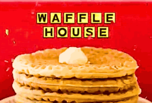 A waffle dish from the Waffle House menu, topped with a dollop of whipped cream.
