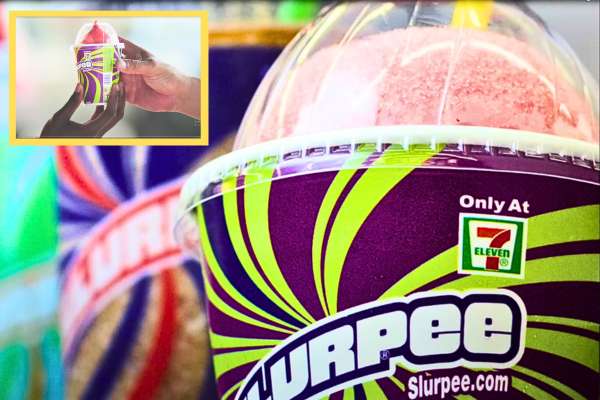 People enjoying Free Slurpee Day at a 7-Eleven store, holding free Slurpees and smiling.