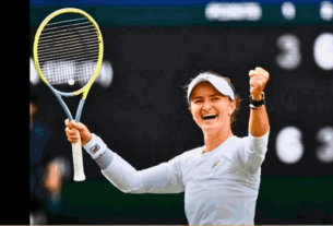 Barbora Krejcikova holding the Wimbledon trophy in celebration after winning the women's Wimbledon final against Jasmine Paolini.