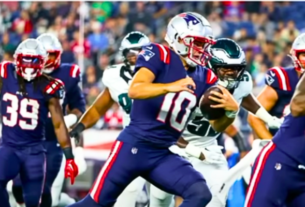Drake Maye in a New England Patriots uniform, delivering a pass during a preseason game, showcasing his skill and potential as the team's future quarterback.