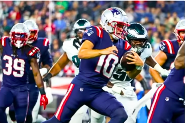 Drake Maye in a New England Patriots uniform, delivering a pass during a preseason game, showcasing his skill and potential as the team's future quarterback.