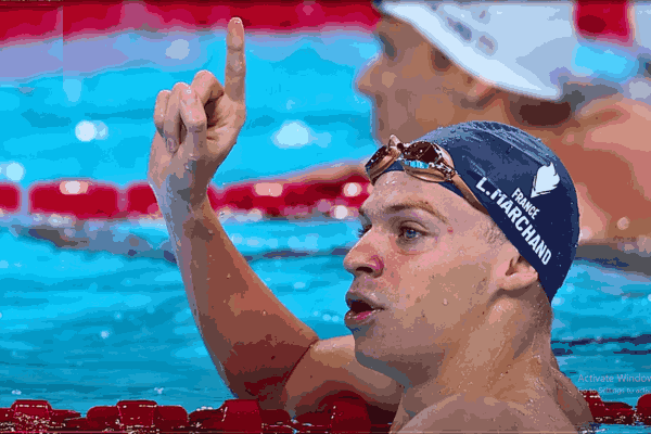 Leon Marchand celebrates winning double gold at the 2024 Paris Olympics, showcasing his medals for the 200m butterfly and 200m breaststroke.