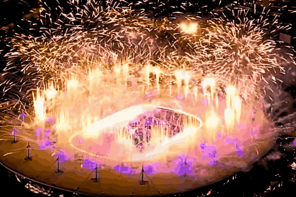 A vibrant scene from the Olympics Closing Ceremony in Paris, featuring a star-studded performance with dazzling lights and cultural displays, symbolizing the transition to Los Angeles as the next host city.