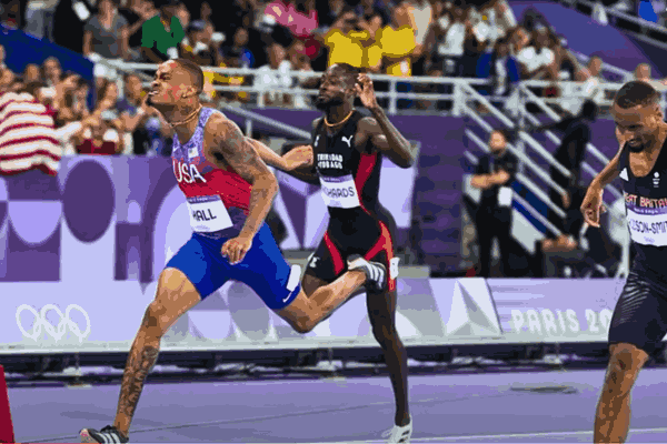 Quincy Hall crossing the finish line to win gold in the 400 meters at the Paris Olympics, capturing his incredible final surge.