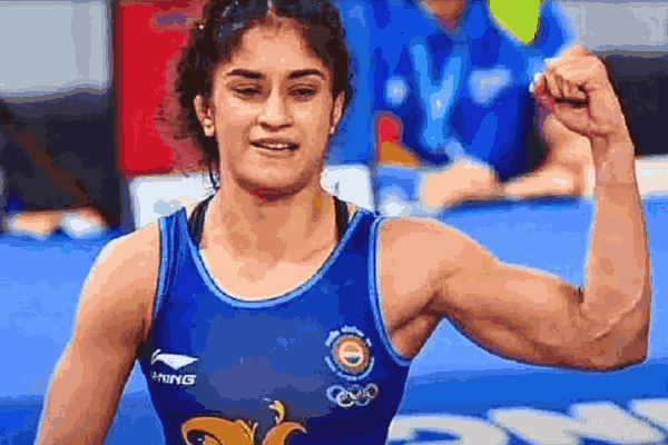Vinesh Phogat celebrates after defeating Yui Susaki in the 2024 Olympic opener, showcasing her resilience and tactical brilliance.