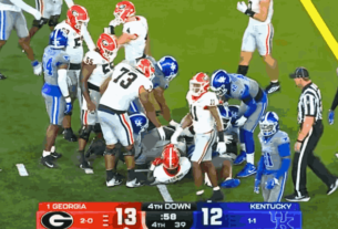Georgia vs Kentucky football game with Georgia Bulldogs and Kentucky Wildcats in action during a key play.