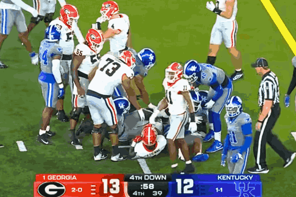 Georgia vs Kentucky football game with Georgia Bulldogs and Kentucky Wildcats in action during a key play.