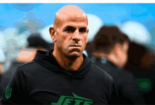 Robert Saleh on the sidelines during an intense NFL game, leading his team with focus and determination.
