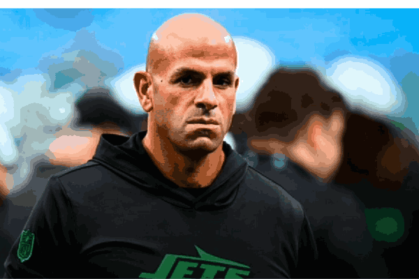 Robert Saleh on the sidelines during an intense NFL game, leading his team with focus and determination.