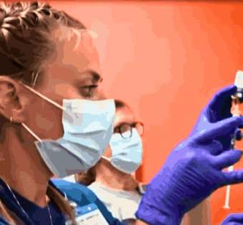 Healthcare professional wearing protective gear examining a patient amid the Mpox Outbreak in California.