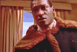 Tony Todd, iconic Candyman star, in a memorable scene showcasing his commanding presence and powerful portrayal in horror cinema.
