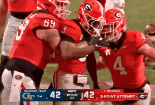Georgia vs Georgia Tech players battling during the intense eight-overtime game where the Bulldogs emerged victorious 44-42.