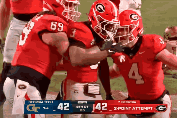 Georgia vs Georgia Tech players battling during the intense eight-overtime game where the Bulldogs emerged victorious 44-42.