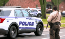Police vehicles outside Abundant Life Christian School after the Wisconsin school shooting, with officers responding to the tragic incident.